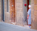 Toscane, lokale vrouw in haar deuropening