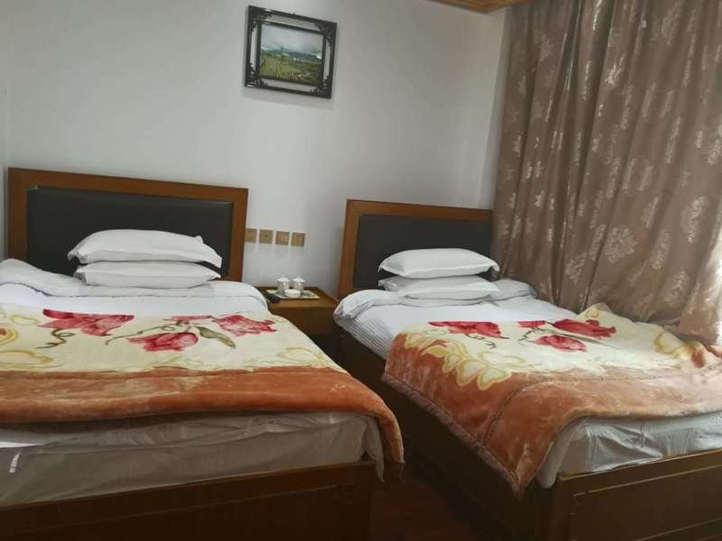 Phuntsok Rabse Hotel - slaapkamer