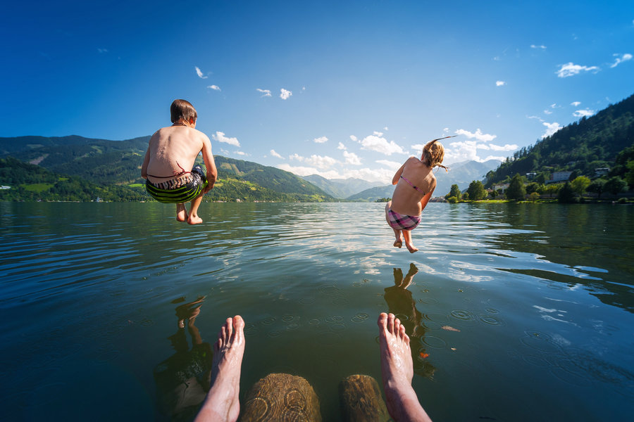 boy and girl swim in lake