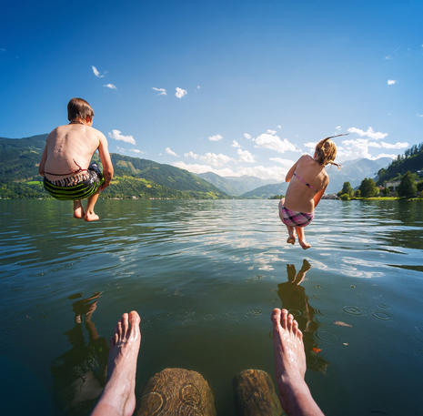 boy and girl swim in lake